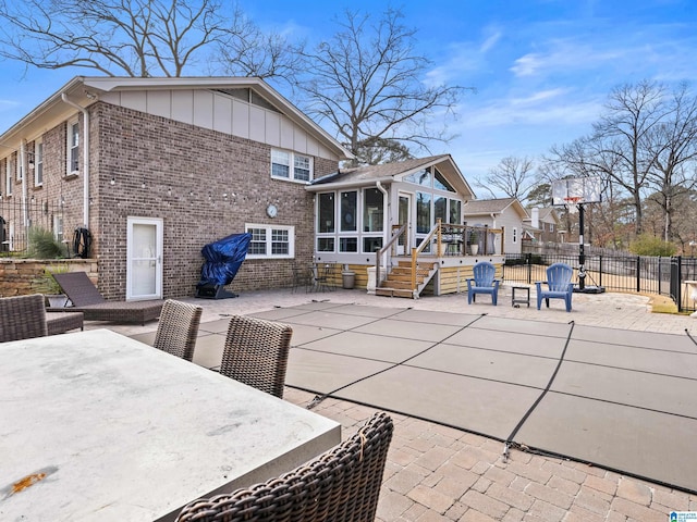 back of house with a sunroom and a patio area