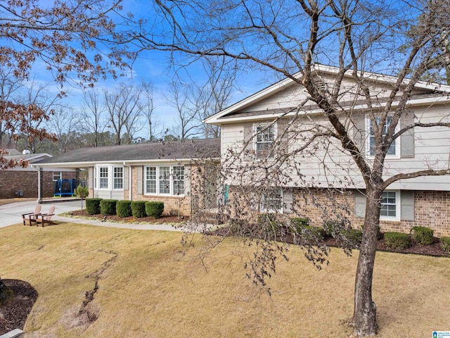 split level home featuring a carport and a front lawn