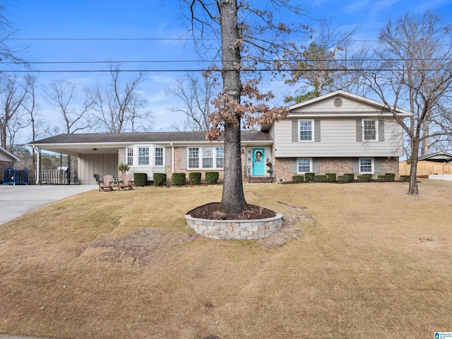 tri-level home featuring a front yard and a carport