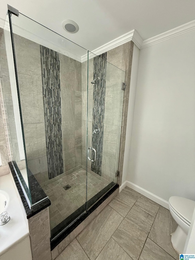 bathroom with tile patterned floors, walk in shower, vanity, crown molding, and toilet