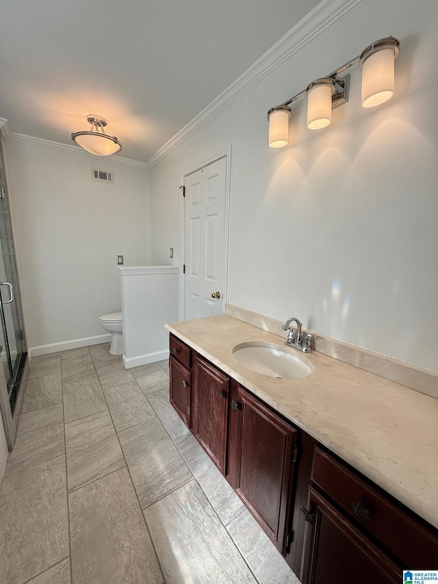 bathroom featuring vanity, toilet, an enclosed shower, and crown molding