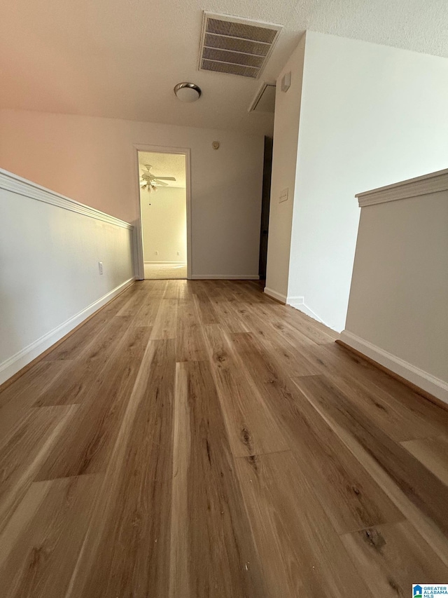 interior space with light hardwood / wood-style floors and a textured ceiling