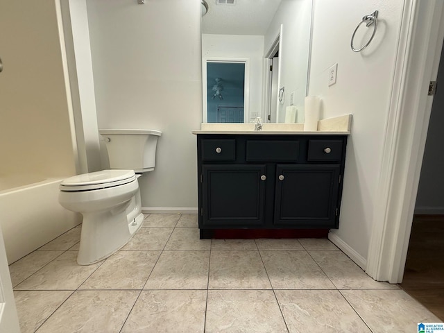 bathroom featuring tile patterned floors, vanity, and toilet