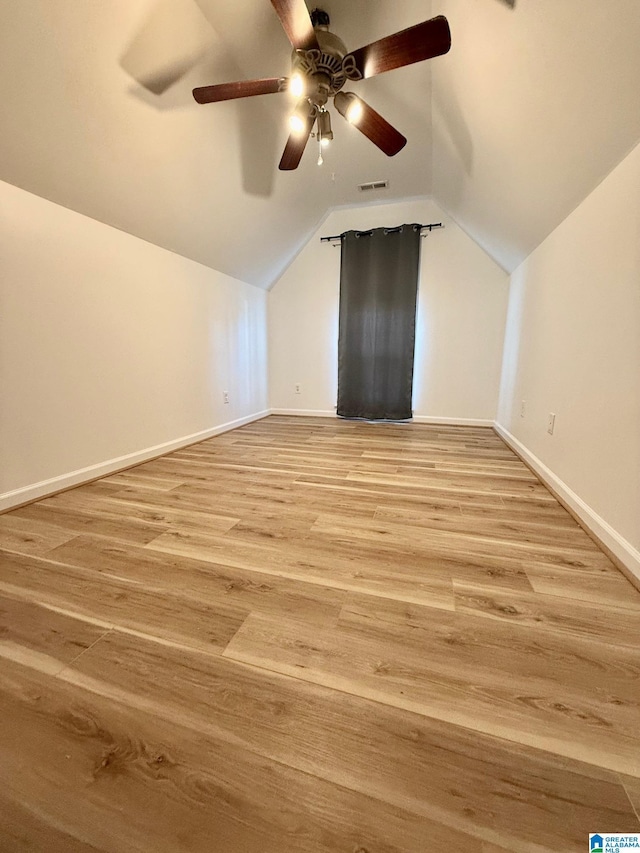 bonus room with ceiling fan, light wood-type flooring, and vaulted ceiling