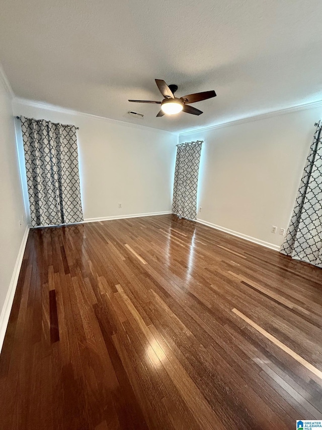 spare room with ceiling fan, dark hardwood / wood-style flooring, crown molding, and a textured ceiling