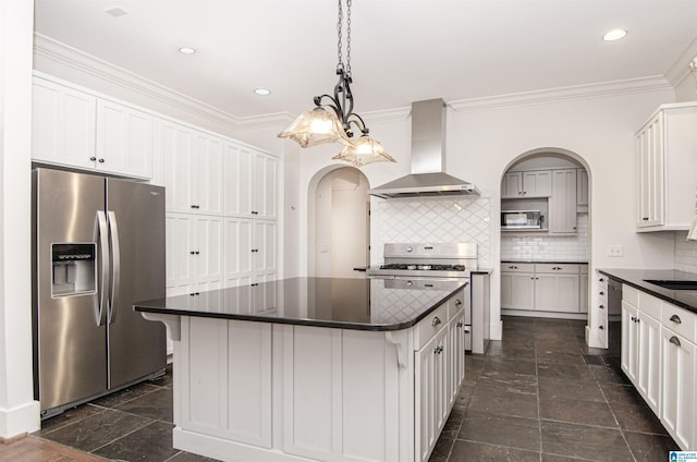 kitchen featuring stainless steel appliances, a kitchen island, wall chimney range hood, and decorative backsplash