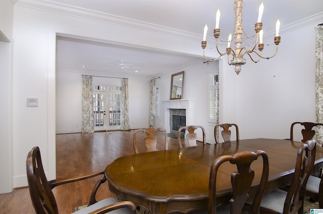 dining area with crown molding, wood-type flooring, ceiling fan, and french doors