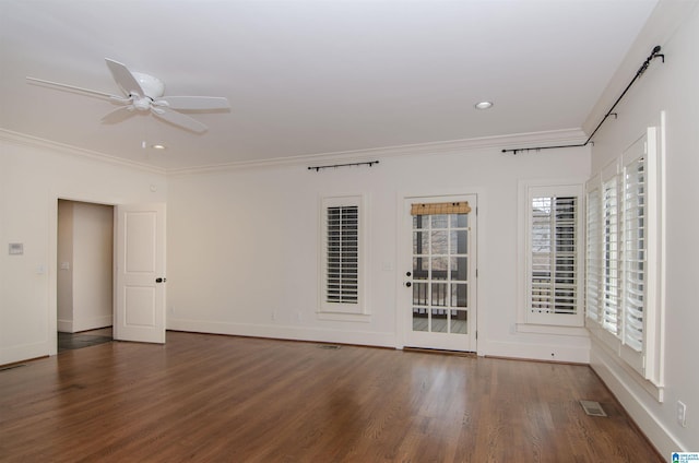 unfurnished room featuring dark hardwood / wood-style flooring, crown molding, and ceiling fan