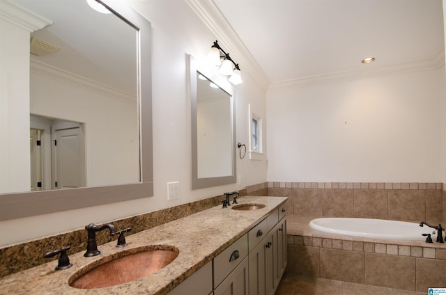 bathroom featuring tile patterned flooring, ornamental molding, tiled tub, and vanity