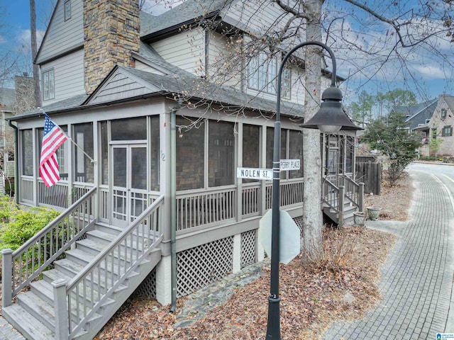 view of side of home featuring a sunroom