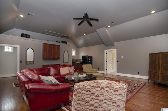 living room featuring light hardwood / wood-style floors, vaulted ceiling, and a wealth of natural light