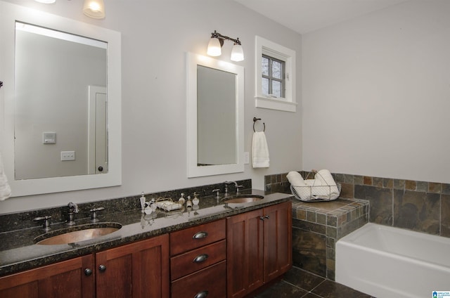 bathroom with tile patterned floors, vanity, and a bath