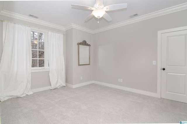 carpeted empty room with crown molding and ceiling fan