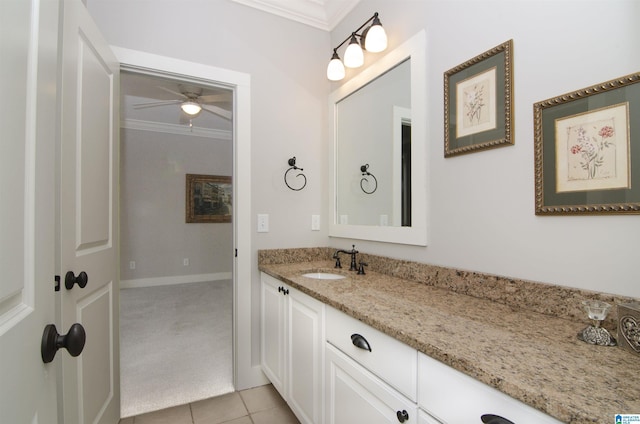 bathroom featuring tile patterned floors, ornamental molding, and vanity