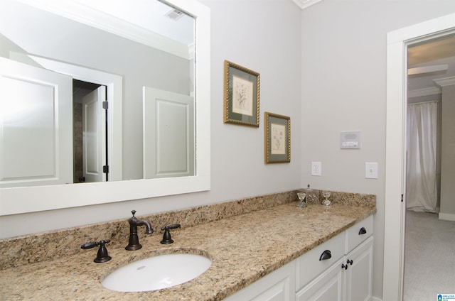 bathroom with crown molding and vanity