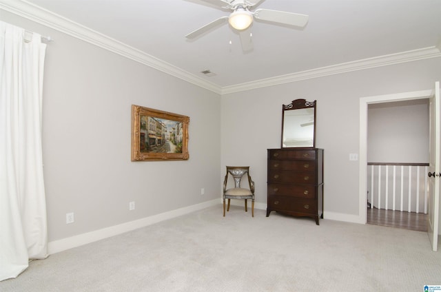 sitting room with crown molding, light colored carpet, and ceiling fan