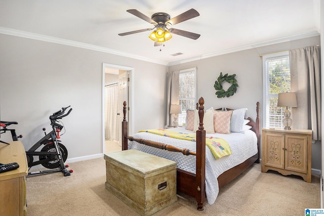 carpeted bedroom featuring ensuite bathroom, ceiling fan, and crown molding