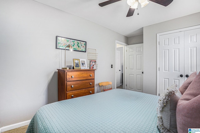 carpeted bedroom with ceiling fan and a closet