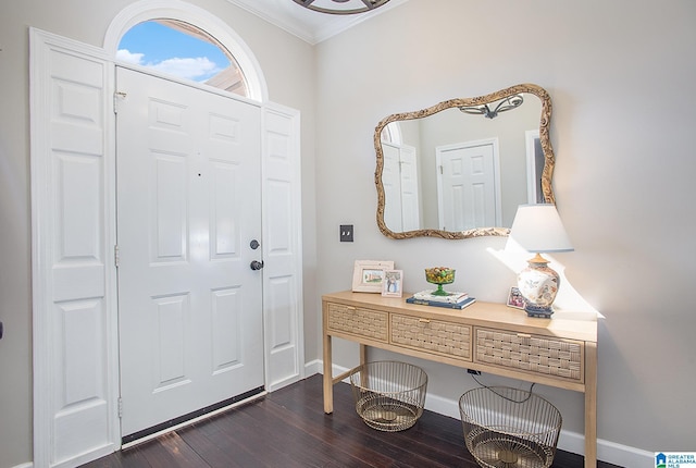 foyer entrance with ornamental molding and dark wood-type flooring