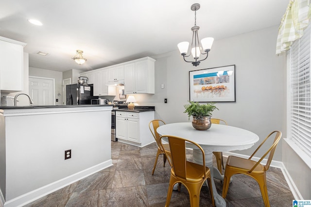 dining space with sink and a chandelier