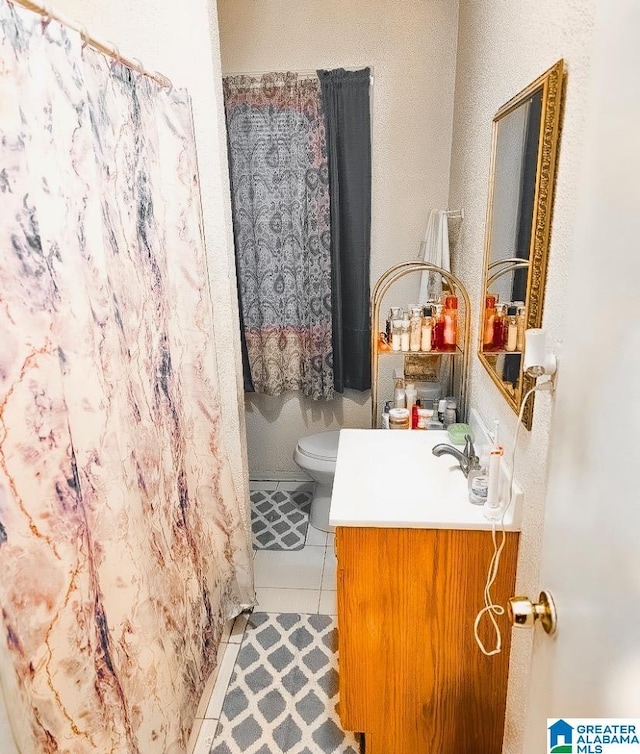 bathroom with tile patterned floors, vanity, and toilet