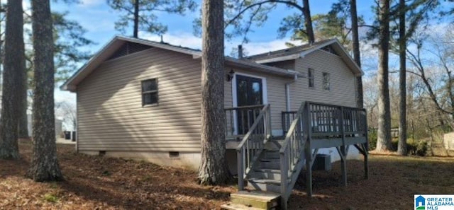 view of side of home with a deck