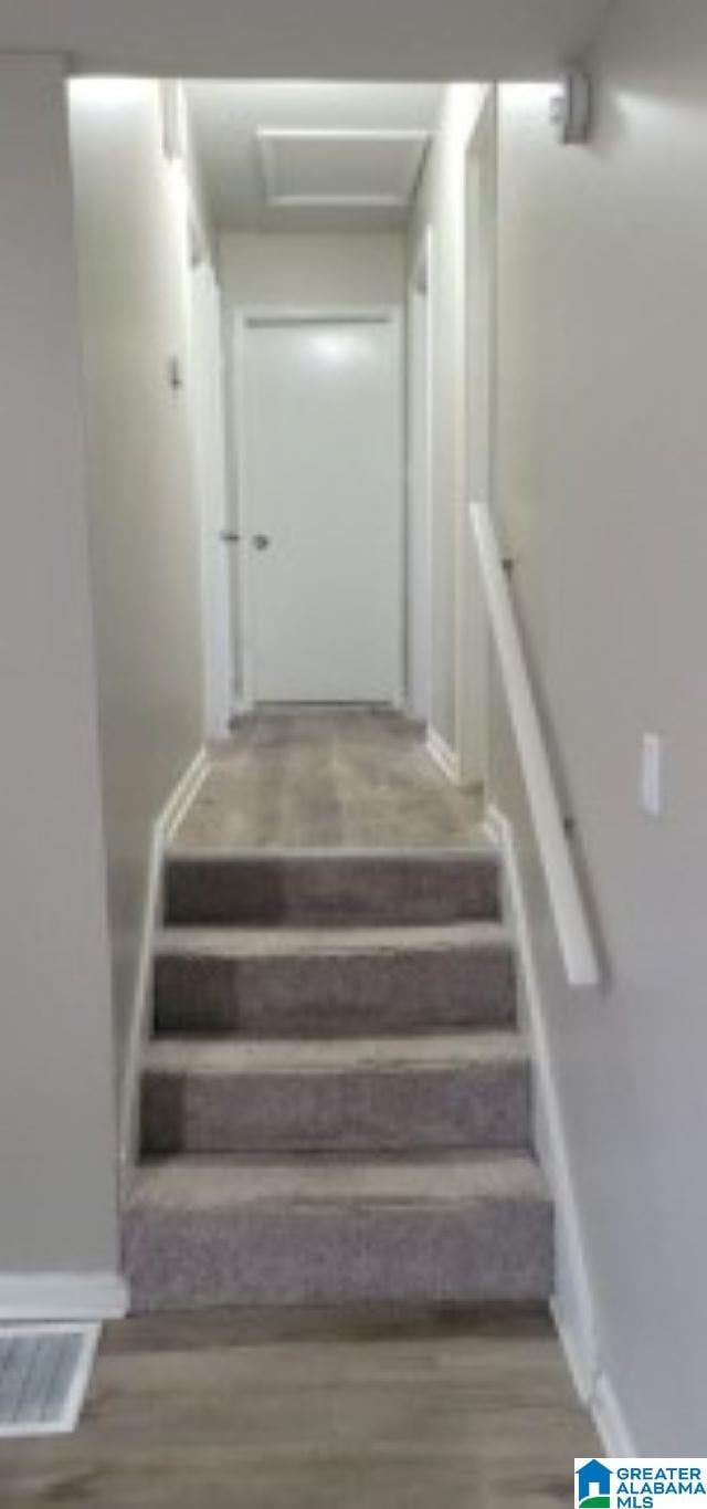 stairway with wood-type flooring