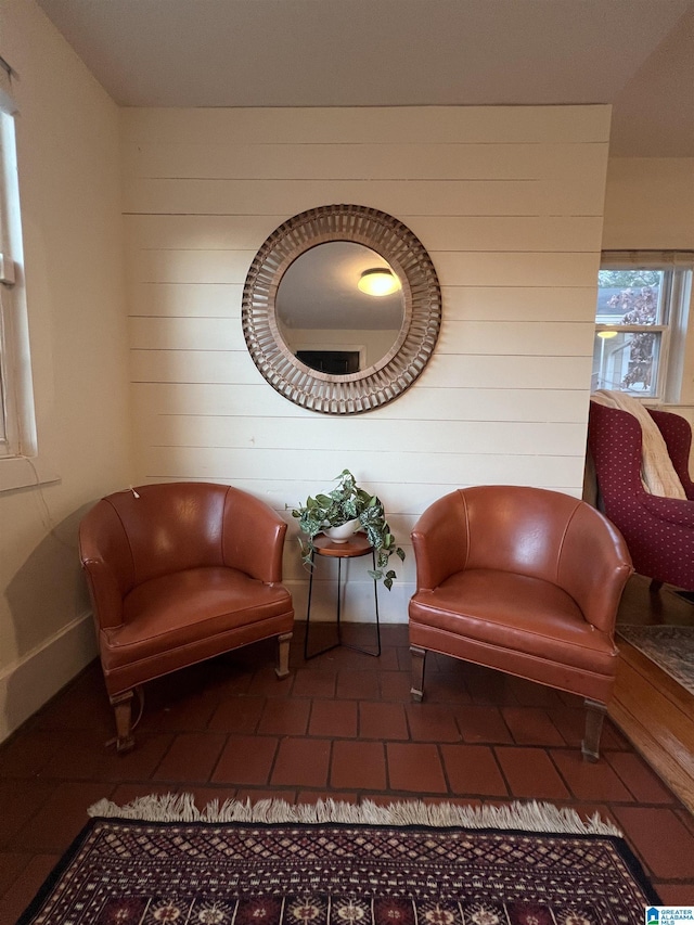 living area featuring dark tile patterned flooring