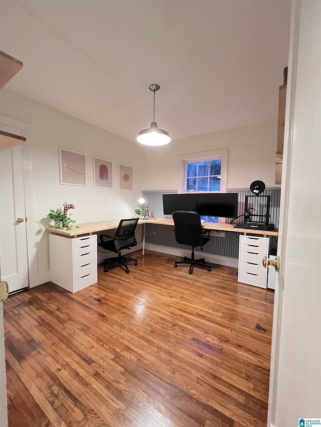 office with light hardwood / wood-style flooring and built in desk