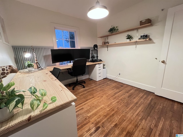 office with built in desk and hardwood / wood-style flooring