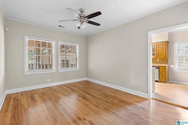 spare room with ceiling fan and light wood-type flooring