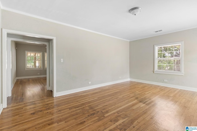 unfurnished room with crown molding and hardwood / wood-style floors