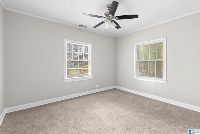 carpeted spare room featuring ceiling fan and crown molding