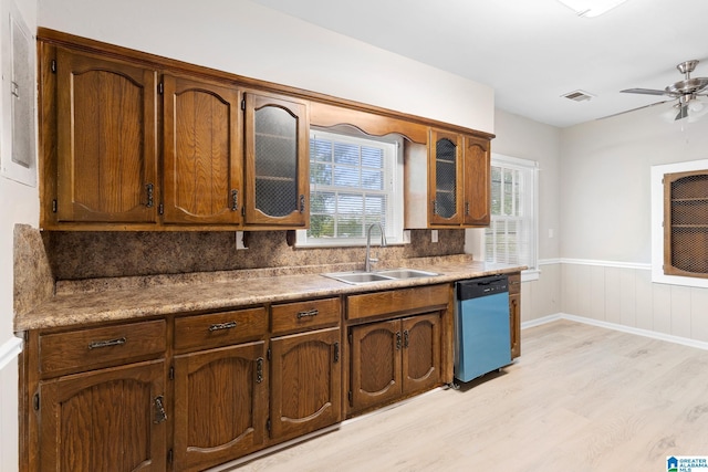 kitchen featuring ceiling fan, sink, stainless steel dishwasher, and light hardwood / wood-style flooring