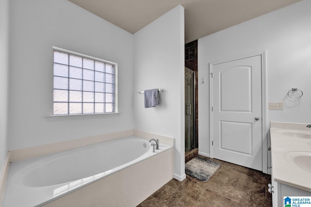 bathroom with vanity and independent shower and bath