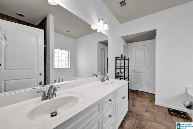 bathroom featuring a tub to relax in and vanity