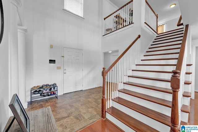 entrance foyer with a towering ceiling and ornamental molding