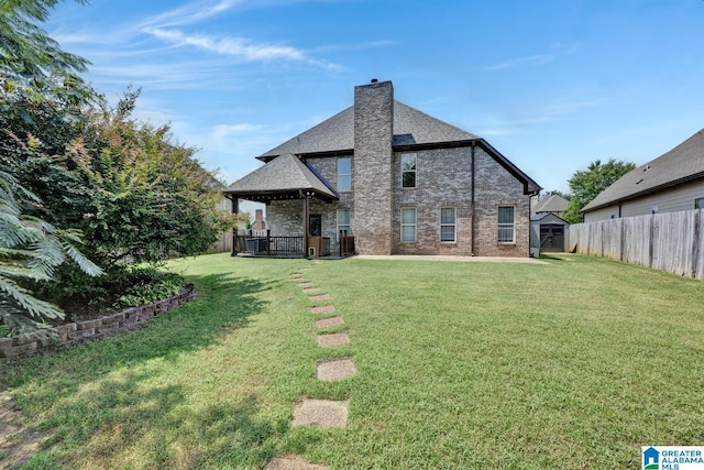 back of house featuring a lawn