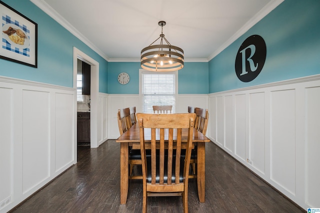 dining room with ornamental molding, a chandelier, and dark hardwood / wood-style floors