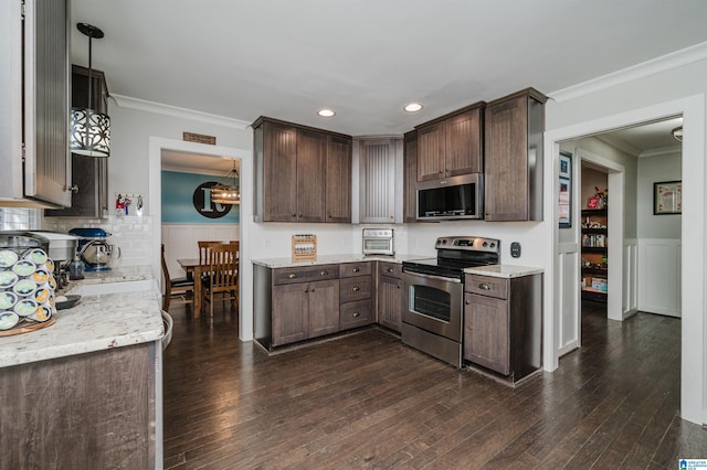 kitchen with pendant lighting, stainless steel appliances, crown molding, dark hardwood / wood-style flooring, and dark brown cabinetry