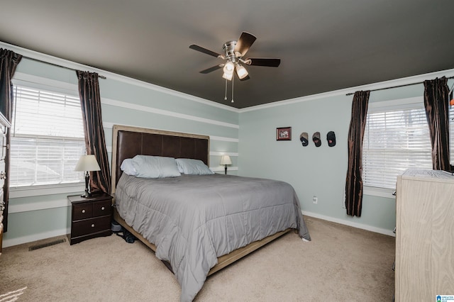 bedroom with light carpet, ceiling fan, and crown molding