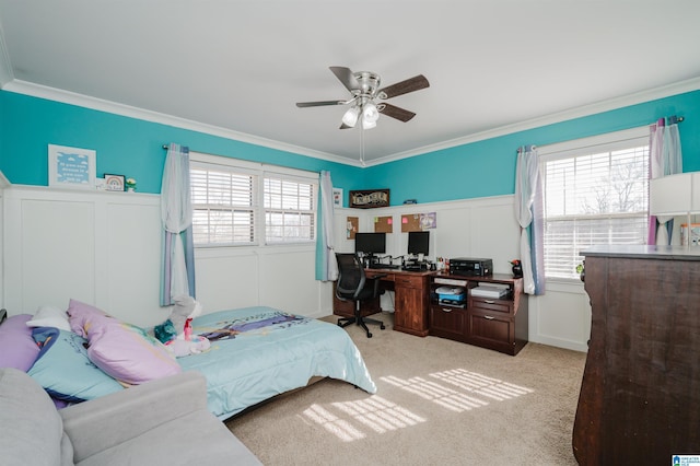 carpeted bedroom with ceiling fan, ornamental molding, and multiple windows