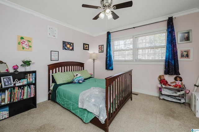 carpeted bedroom featuring ceiling fan and ornamental molding