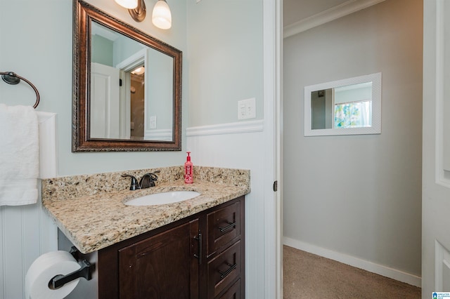 bathroom with ornamental molding and vanity