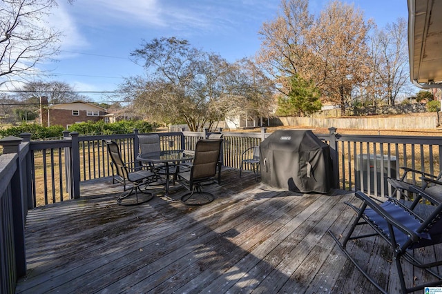 wooden terrace with a grill