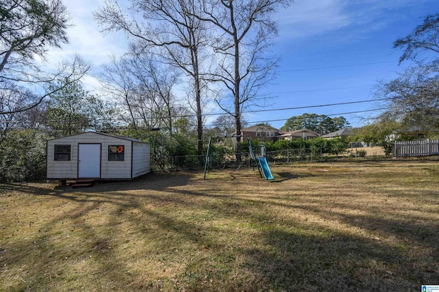 view of yard featuring a playground and a storage unit