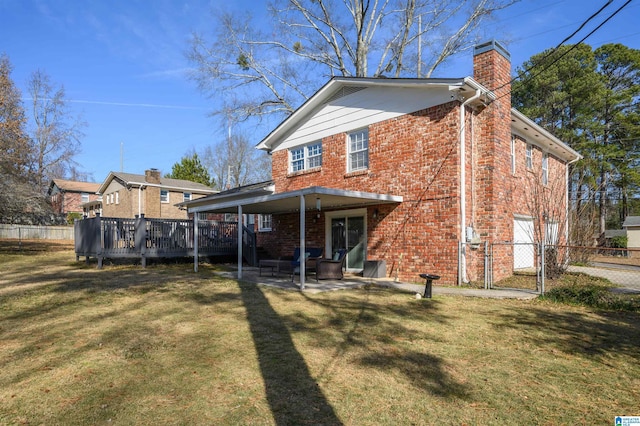 back of property with a patio area, a yard, and a wooden deck