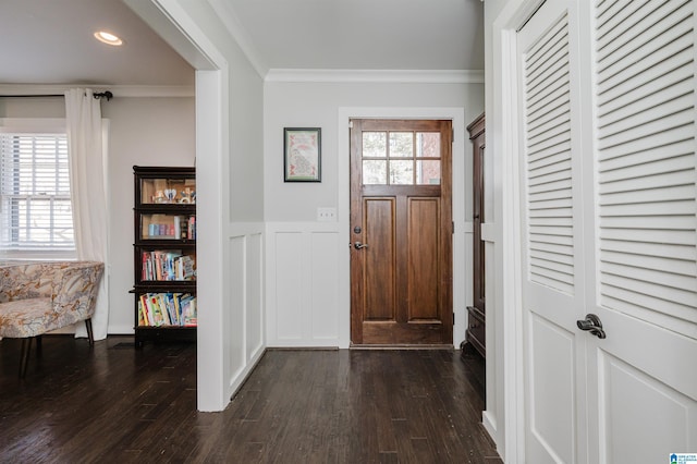 foyer entrance featuring crown molding and dark wood-type flooring