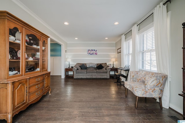 living room with crown molding and dark hardwood / wood-style floors