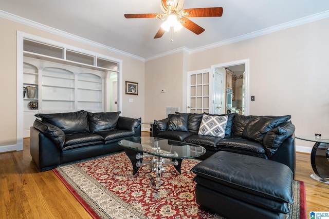 living room with hardwood / wood-style floors, ceiling fan, ornamental molding, and french doors